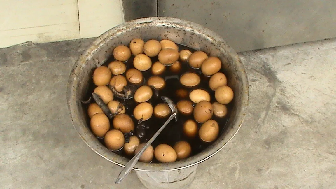 Eggs simmering in a dark broth, used here as a visual analogue rather than a photograph of Virgin Boy Eggs